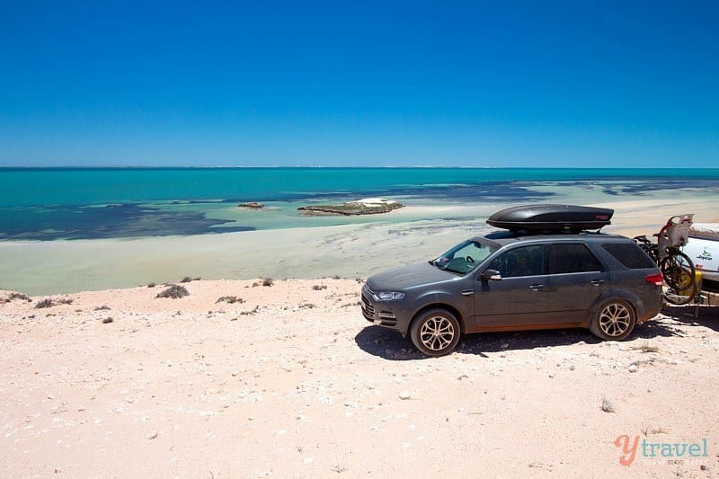 car on dirt road beside beach World Heritage Drive, Shark Bay, Western Australia