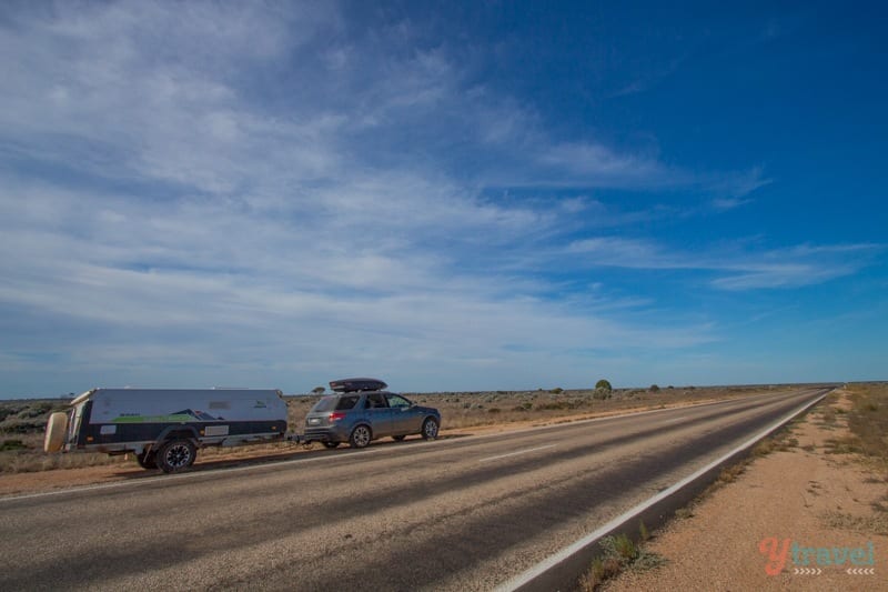 A truck driving down a dirt road