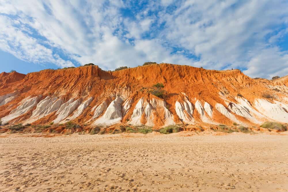 red and white cliffs on the beach of Praia da Falésia Portugal