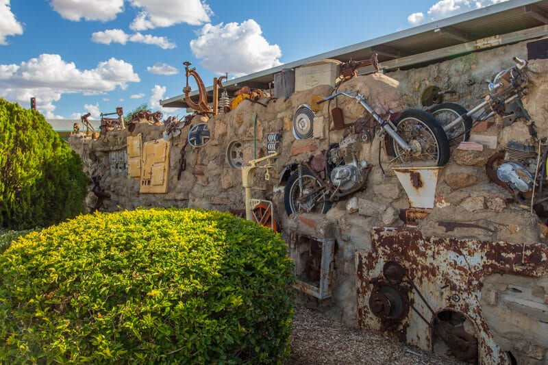 clay wall filled with motorbike parts