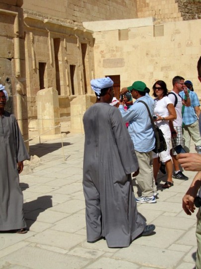 a group of people standing in front of a stone building