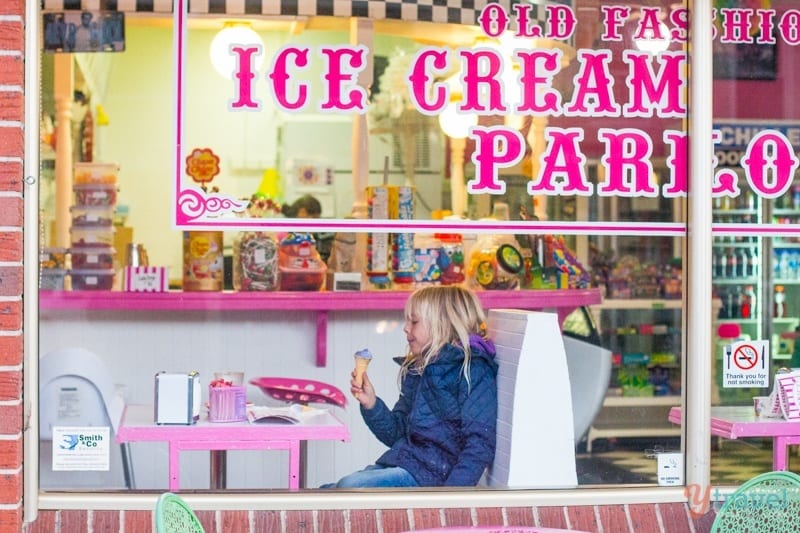 girl sitting on chair eating ice cream