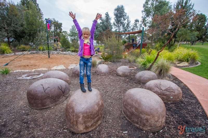 girl standing on rock 