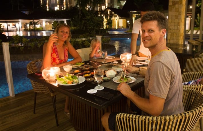 people sitting at a table with food