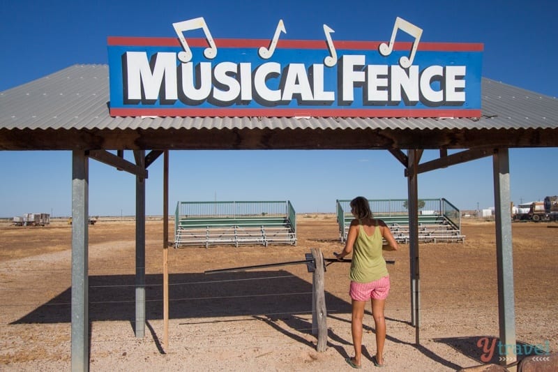 woman standing in front of a sign