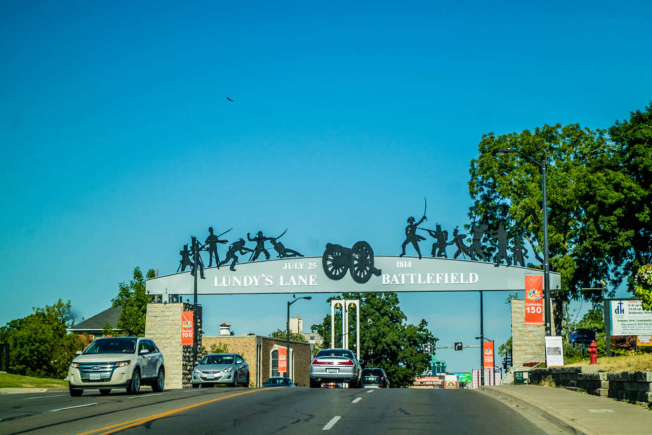 Historic Lundy’s Lane Battlefield archway in Niagara Falls with silhouetted figures representing the 1814 battle.