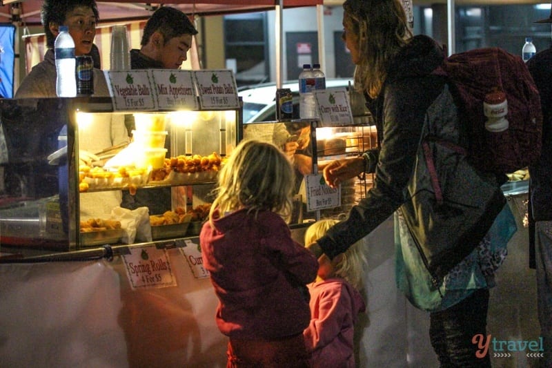 people ordering food at a store