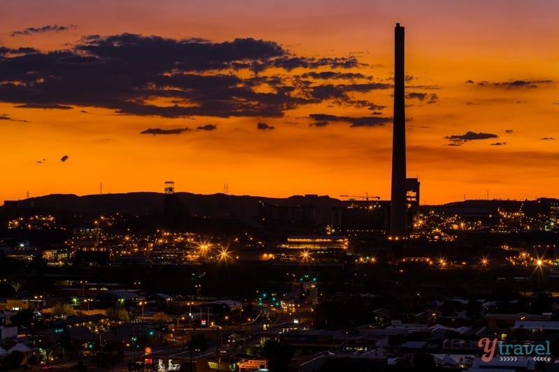 stunning orange Sunset sky with tower and mountain silhouette