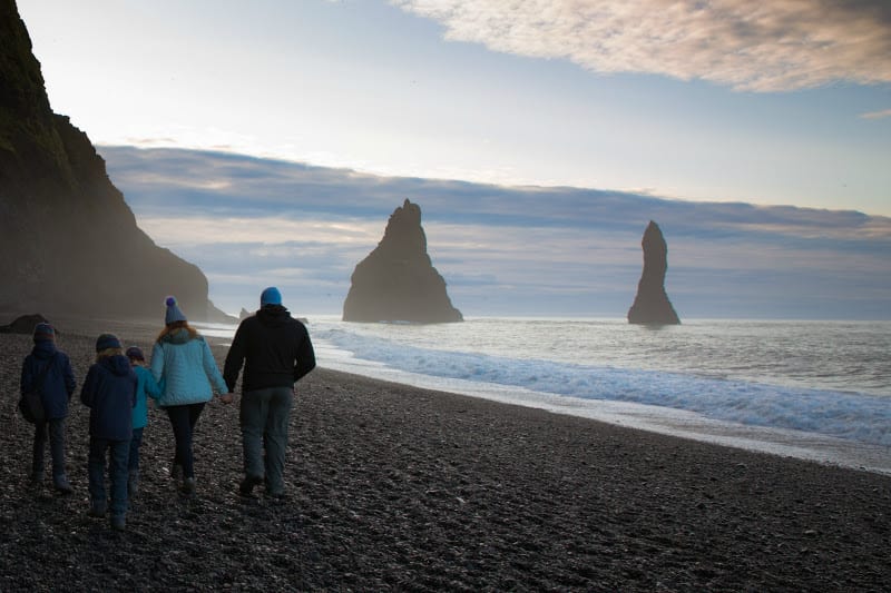 family walking on Reynisfjara Black Sand-Beach, Iceland