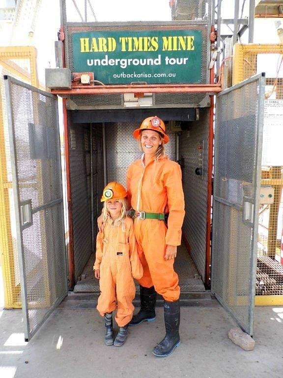 mother and child standing at entrance to Mount Isa mine tour in orange jumpsuits