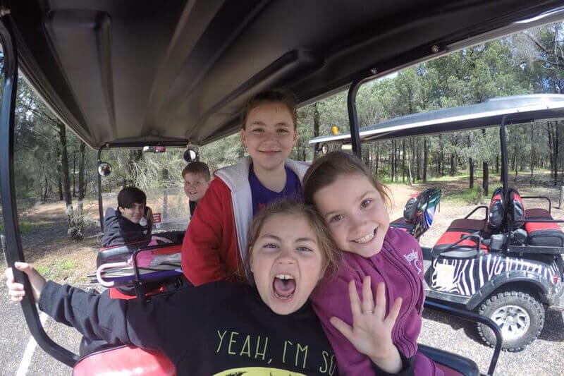 kids in golf cart posing