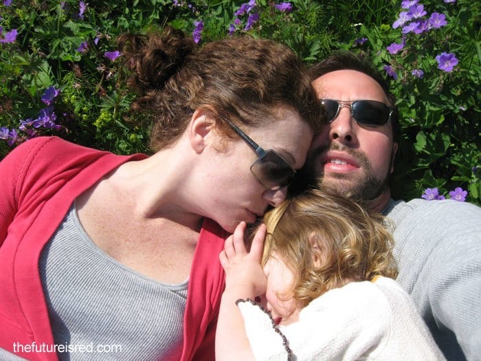 family lying on grass