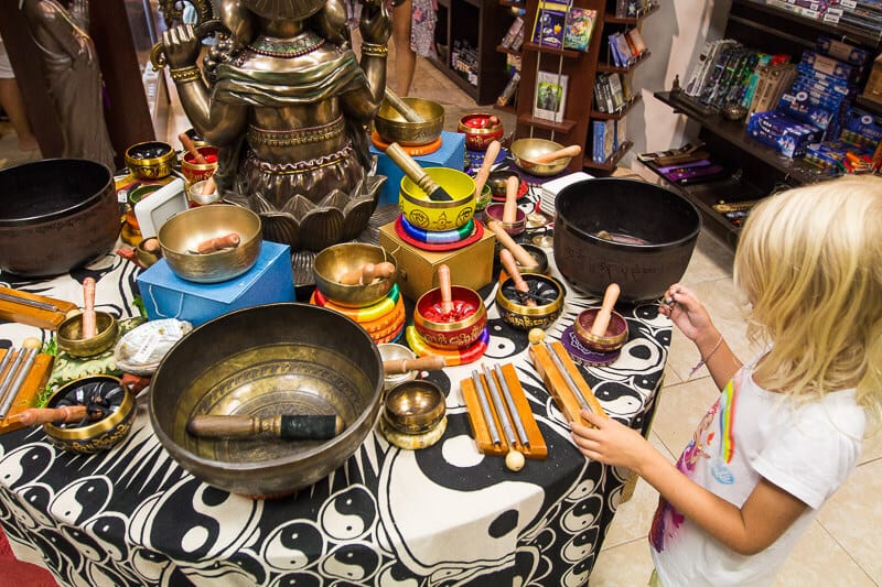 girl looking at singing bowls on display at Celestial Treasures 