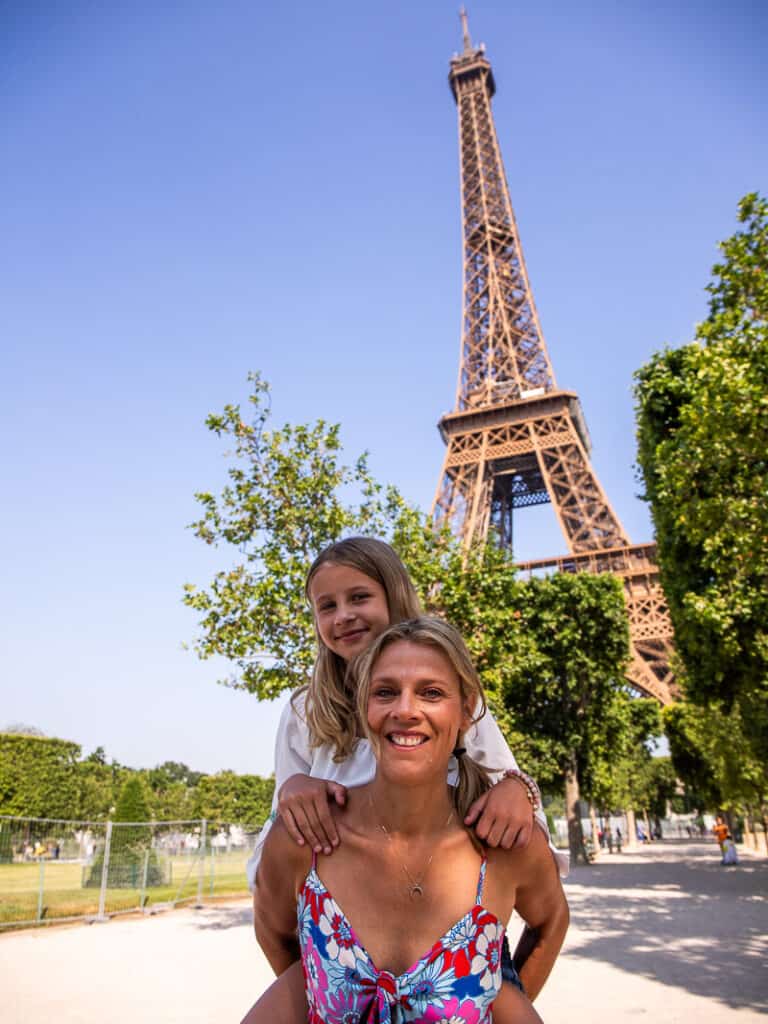 savannah on caroline's back in front of the eiffel tower