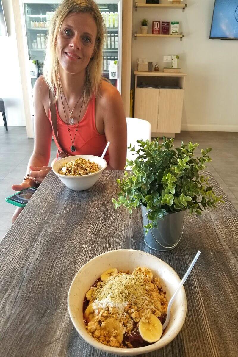 woman eating granola bowl