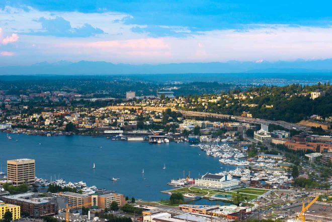 Aerial view of Seattle showing Lake Union densely packed with boats and the surrounding urban landscape during twilight