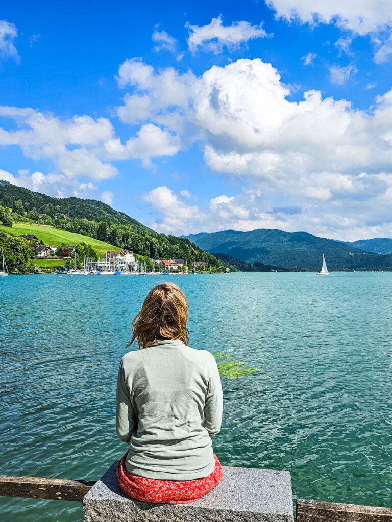 woman sittong on bench looking at mond lake views