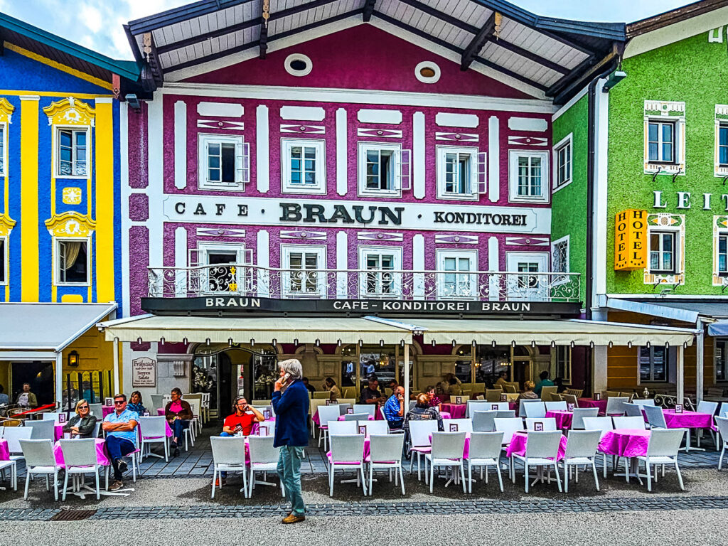 people dining outside colorful buildings