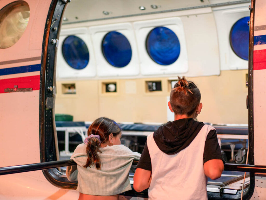 children looking inside royal flying doctor's plane