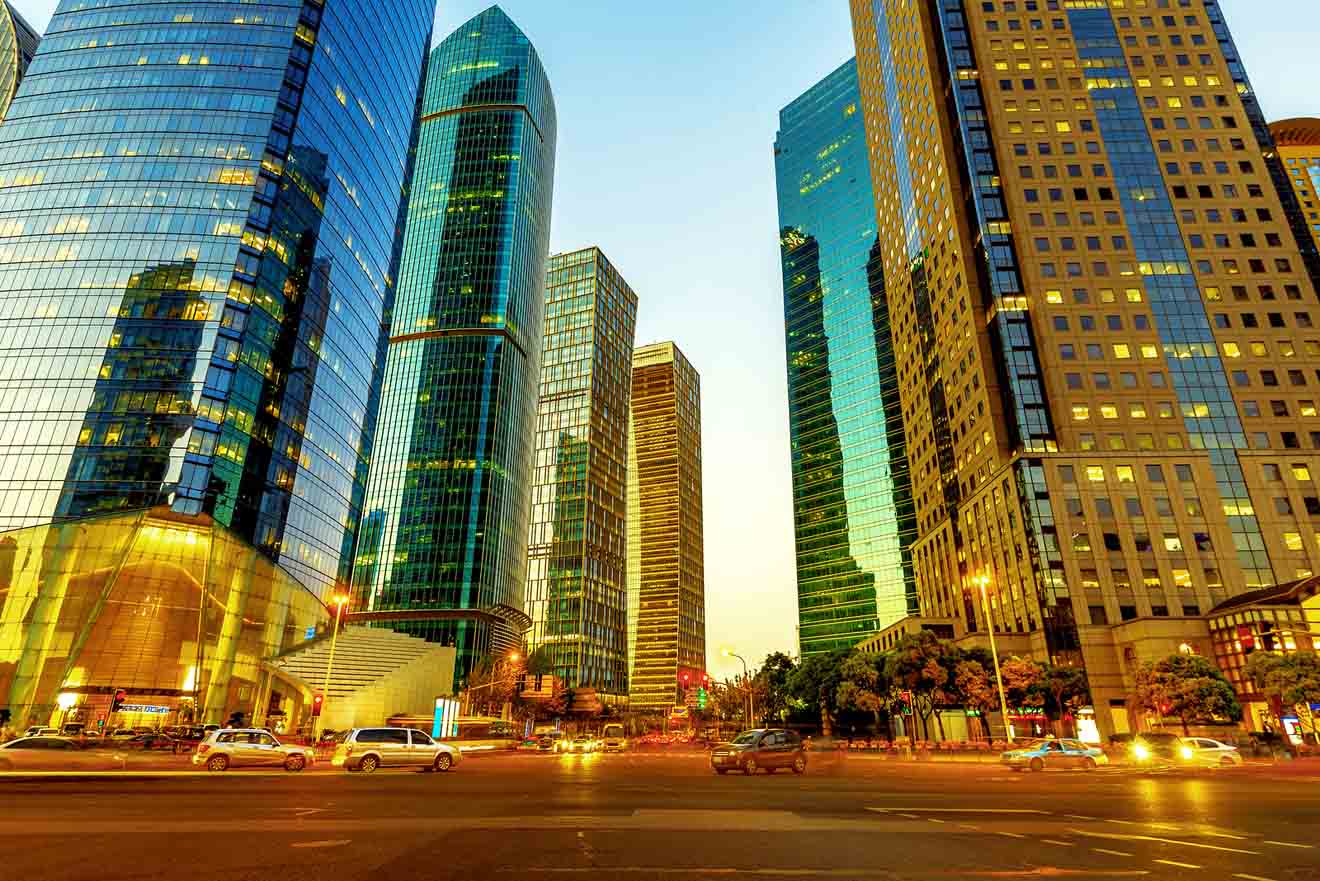 Twilight view of Shanghai's bustling city center with glowing skyscrapers and busy streets reflecting the vibrant city life.