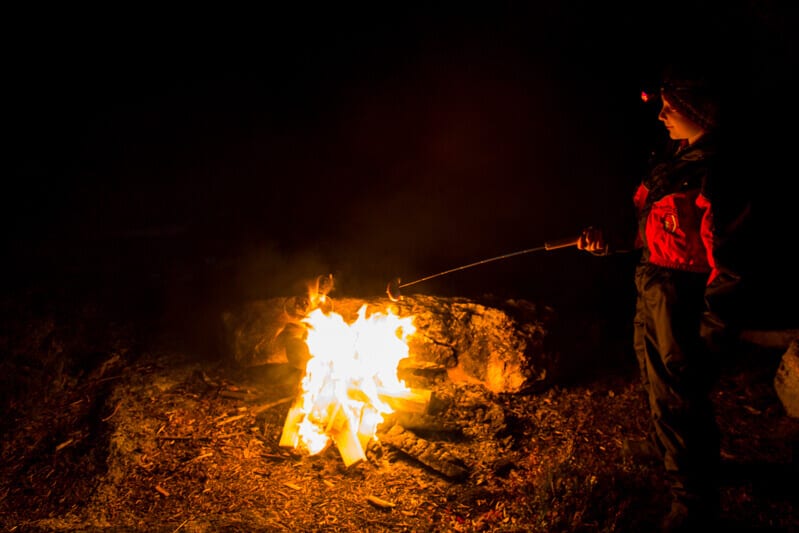 person roasting smores over campfire