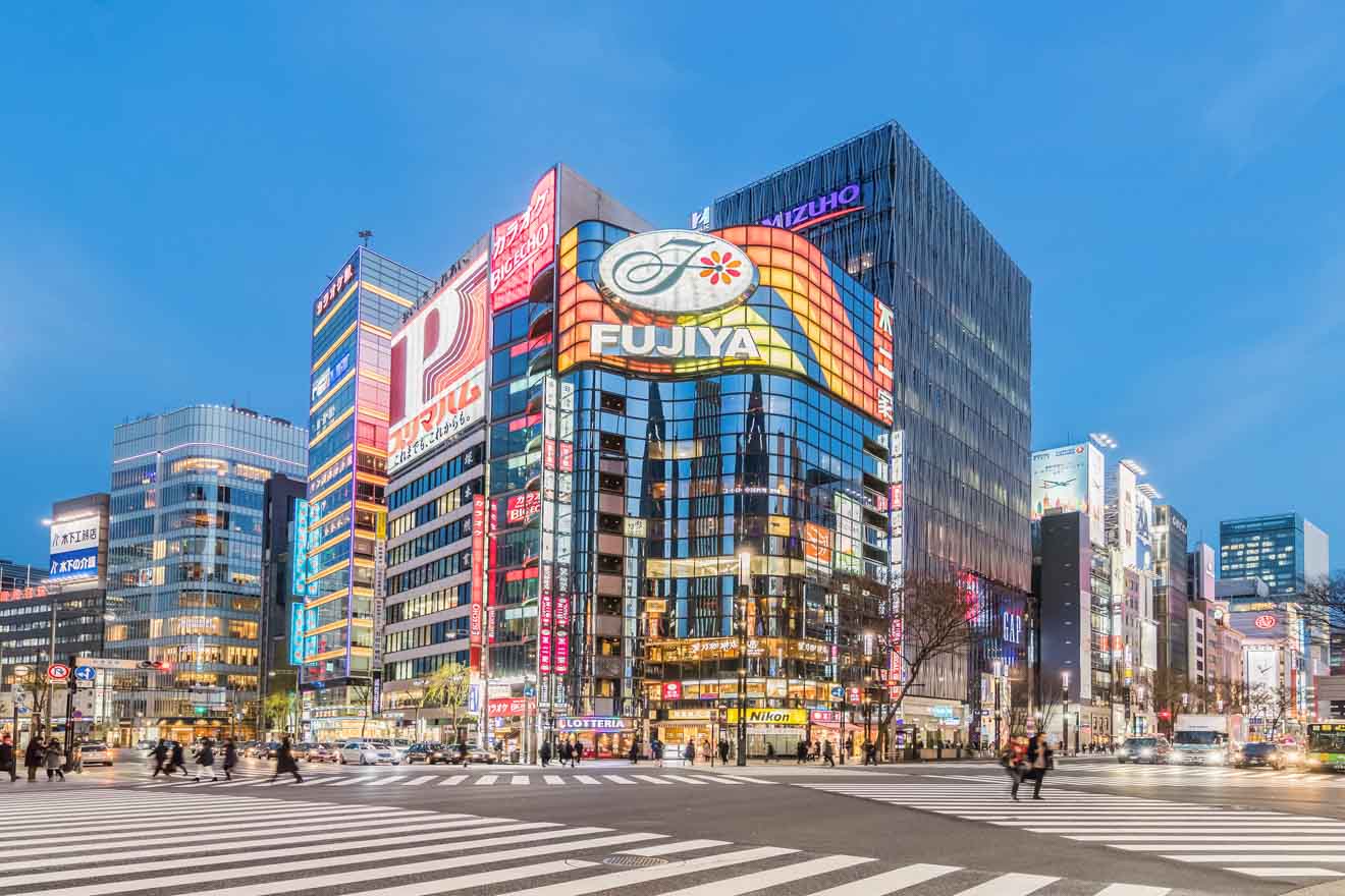 Twilight view of the Ginza district in Tokyo, featuring the iconic FUJIYA sign and bustling street activity.