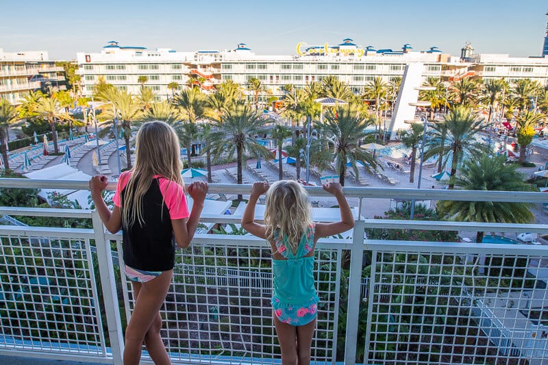 girls looiking out over balcony over pool at Cabana Bay Beach Resort