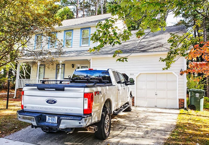 A truck is parked in front of a house