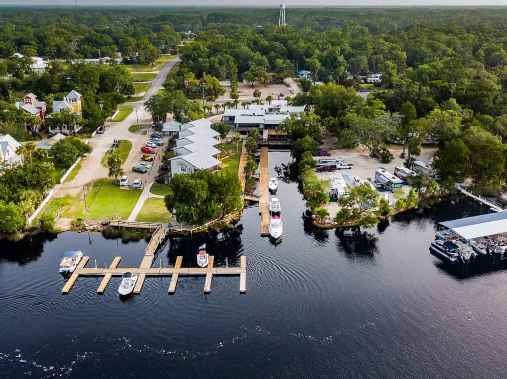 Aerial photo of a resort by a river.