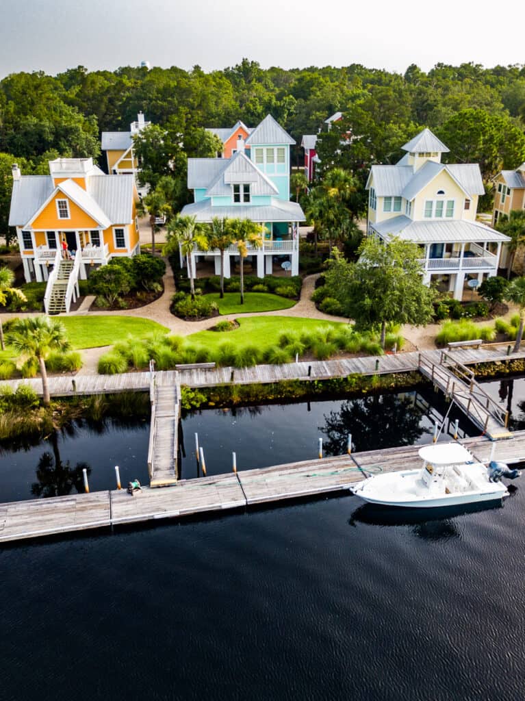 Houses and a boat by a river.