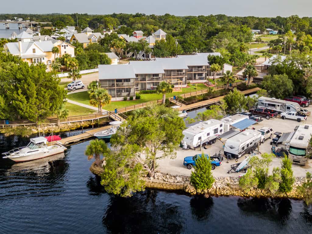 Aerial photo of a resort by a river.