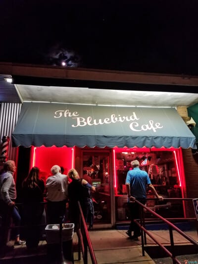 people lining up outside the blue bird cafe