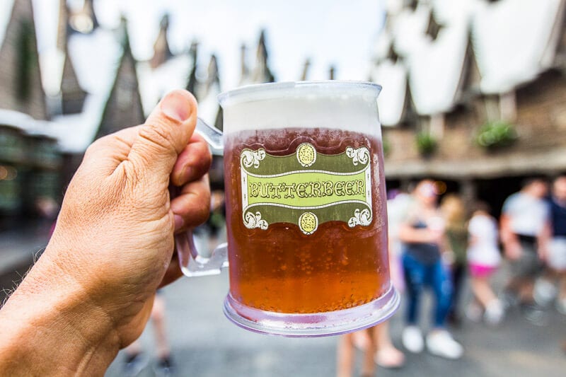 man holding Butterbeer at The Wizarding World of Harry Potter in Universal Orlando Resort