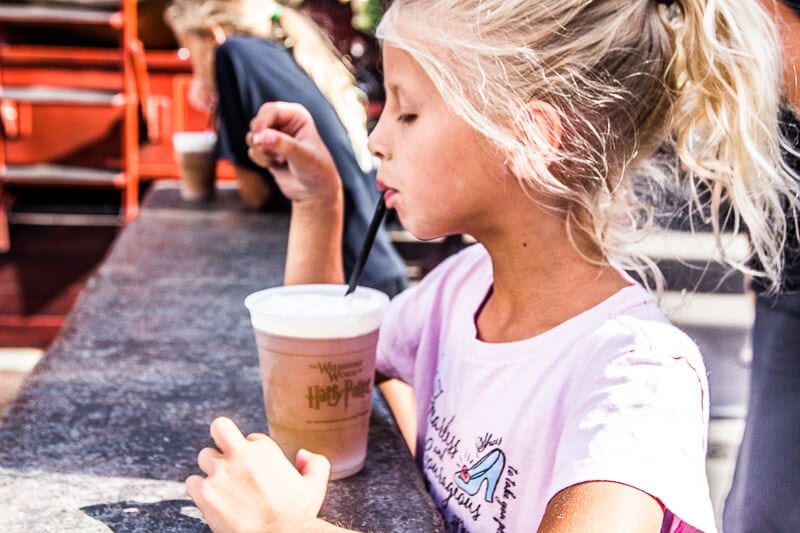 girl drinking out of a cup