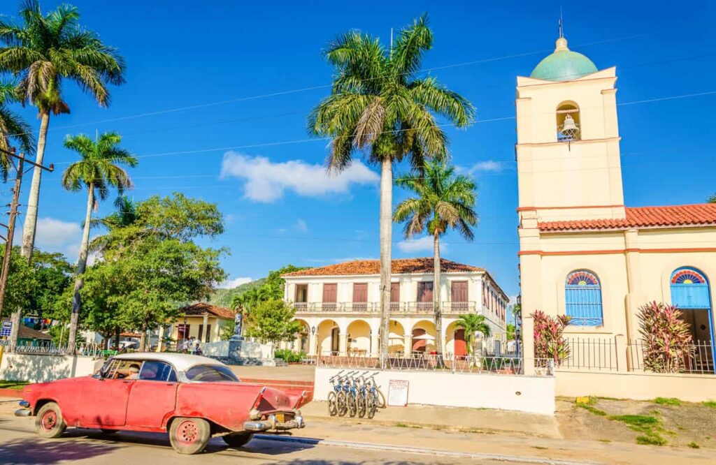  Purple classic American car on one main street of Vinales