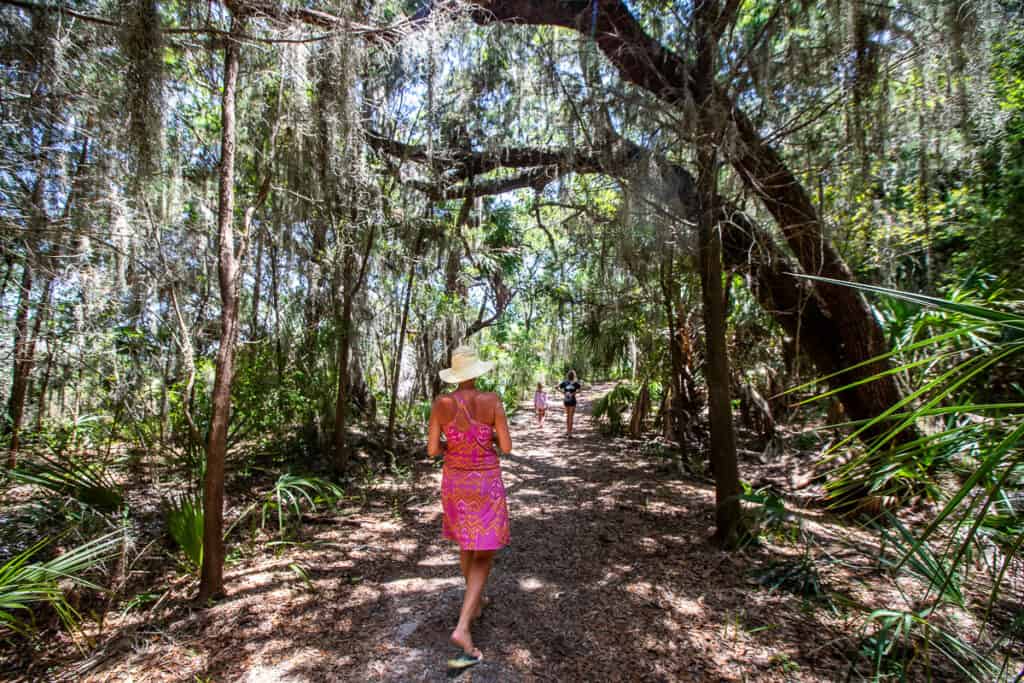 Lady walking a trail on an island.