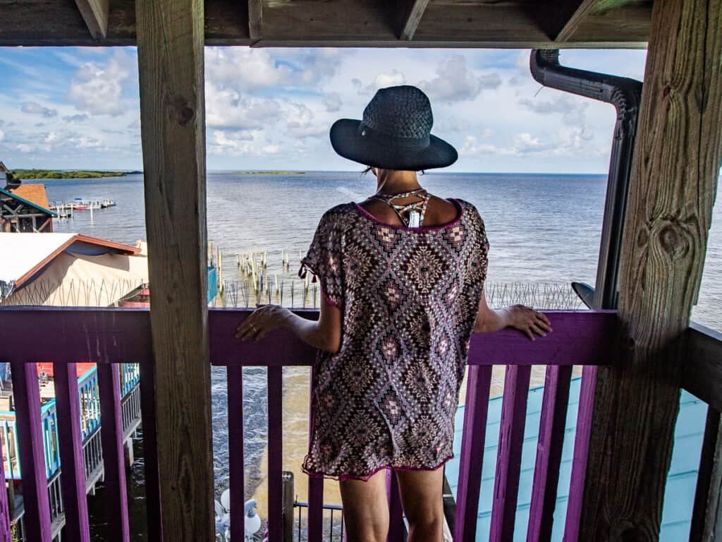 Woman looking out over the water from a deck.