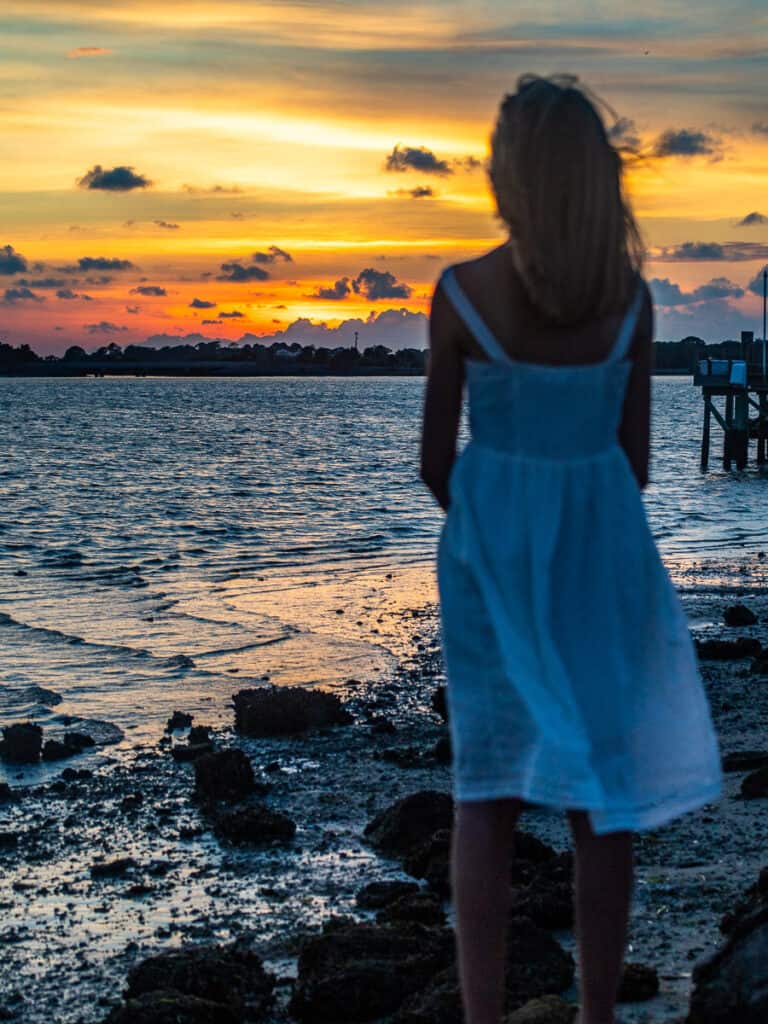 Young girl watching a sunset.