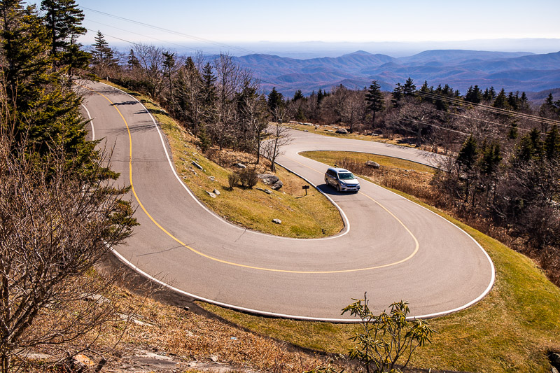 car driving on a winding path up a mountain