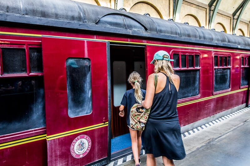 people walking onto a train