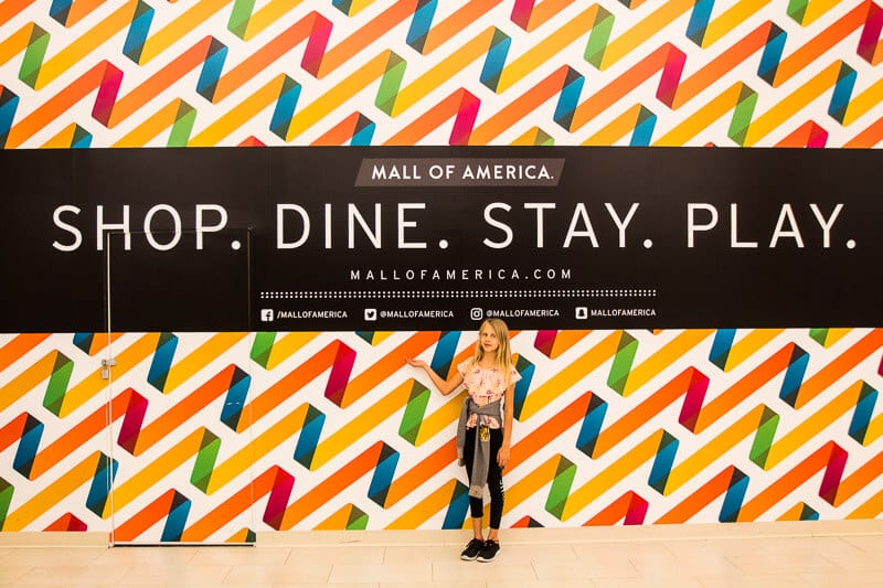 girl posing in front of Mall of America, mural