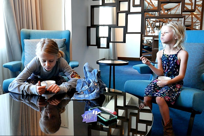 girls sitting at a coffee table