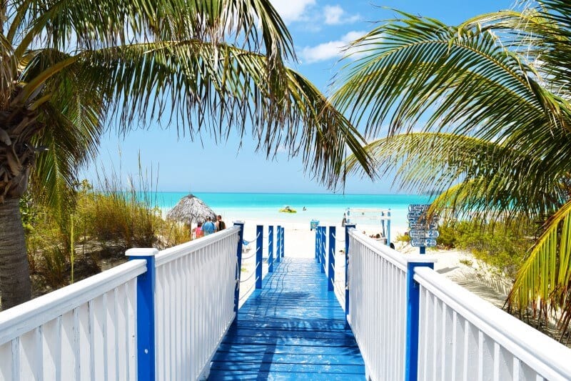 blue boardwalk leading to beach in cuba