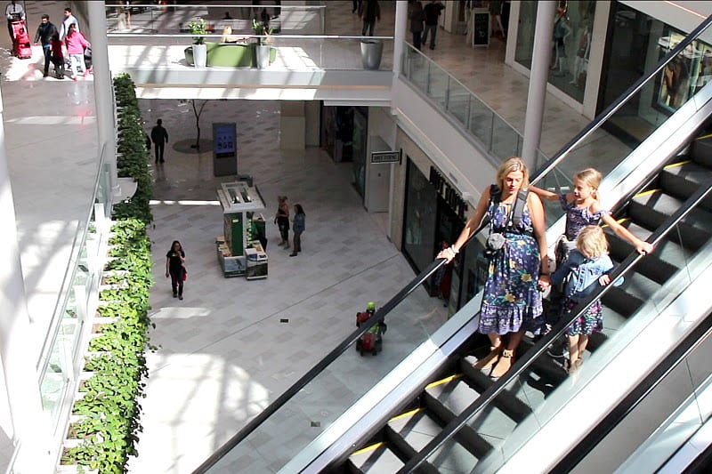 woman and children going down escalator at the Mall of America, Bloomington, Minnesota