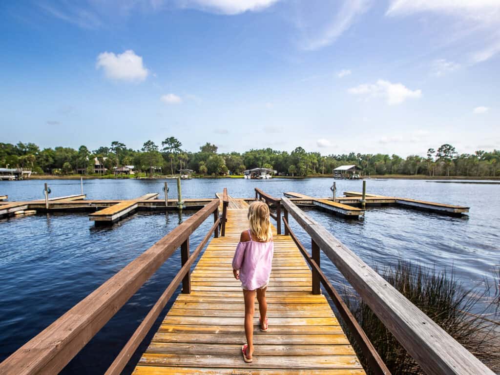 Young girl walking along a jetty.