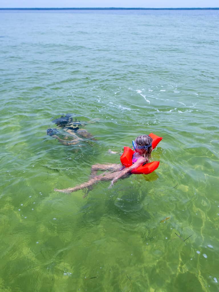 Mom and daughter snorkeling.