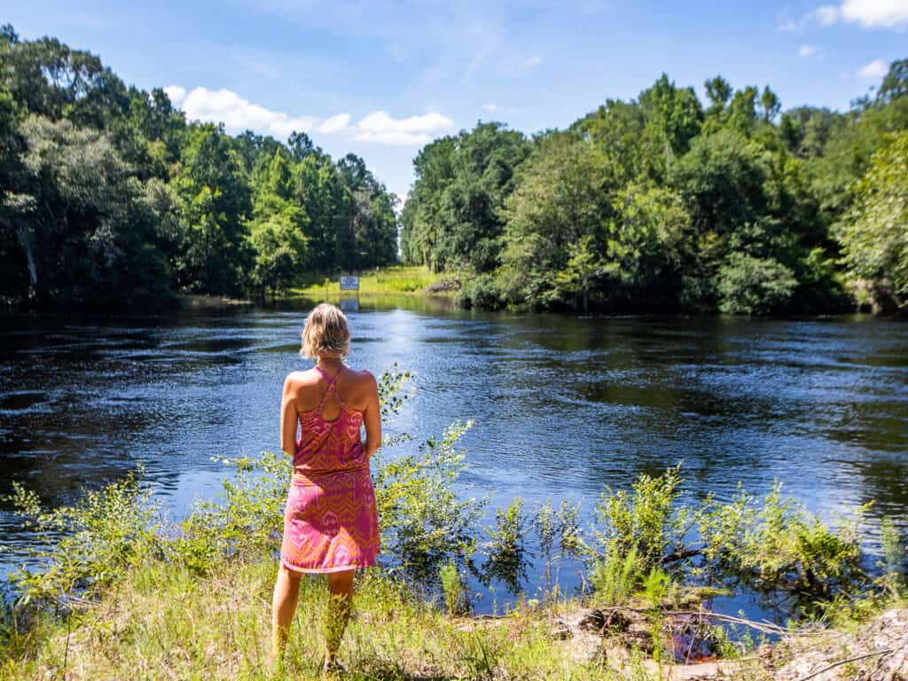 Woman standing by a river.