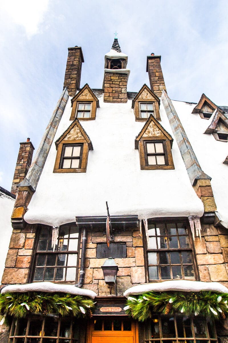 snow covered building in Hogsmeade Village inside The Wizarding World of Harry Potter at Universal Orlando